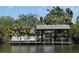 Waterfront property featuring a private boat dock with a boat lift and a white fenced deck for outdoor enjoyment at 5002 S Shore Crest Cir, Tampa, FL 33609