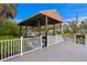 A wooden boat house sits over the canal with white railing and a grey composite dock at 5002 S Shore Crest Cir, Tampa, FL 33609