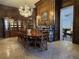 An elegant dining room features wood paneling, a grand chandelier, and a classic china cabinet at 5002 S Shore Crest Cir, Tampa, FL 33609