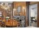 Elegant dining room featuring rich wood paneling, chandelier, and fireplace with marble surround at 5002 S Shore Crest Cir, Tampa, FL 33609