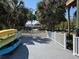 Large dock with gray composite decking, white railings, and plenty of room for chairs to enjoy the waterfront views at 5002 S Shore Crest Cir, Tampa, FL 33609