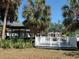 View of private dock with boat house, lift, and spacious deck overlooking the canal with access to the open water at 5002 S Shore Crest Cir, Tampa, FL 33609