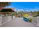 A grey composite dock features a kayak rack, overlooks the canal and has white railings at 5002 S Shore Crest Cir, Tampa, FL 33609