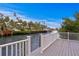 A grey composite dock with white railings looks out over the canal with waterfront homes at 5002 S Shore Crest Cir, Tampa, FL 33609