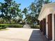 Brick driveway leading up to the garage of this property. The driveway is lined with trees, shrubbery, and other greenery at 5002 S Shore Crest Cir, Tampa, FL 33609