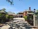 Wide brick driveway leading to a grand brick home and carriage house with ample parking at 5002 S Shore Crest Cir, Tampa, FL 33609