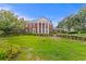 Stately brick home with imposing columns and manicured lawn offers classic curb appeal at 5002 S Shore Crest Cir, Tampa, FL 33609