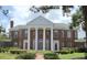 Stately brick home showcasing prominent white columns and well-manicured landscaping at 5002 S Shore Crest Cir, Tampa, FL 33609