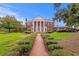 Grand brick home with stately columns, manicured hedges, and brick pathway exudes elegance at 5002 S Shore Crest Cir, Tampa, FL 33609