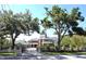 Elegant brick home with mature trees, gated entrance, and American flag adds to its charm at 5002 S Shore Crest Cir, Tampa, FL 33609