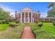 Stately brick home with white columns and trim sits at the end of brick path through manicured lawn at 5002 S Shore Crest Cir, Tampa, FL 33609