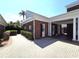 View of brick home with a columned, covered drive and well-manicured landscaping at 5002 S Shore Crest Cir, Tampa, FL 33609
