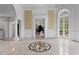 Bright foyer with marble floors, crystal chandelier, and open doorway to a room with a piano at 5002 S Shore Crest Cir, Tampa, FL 33609