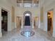 A grand foyer features marble floors, ornate columns, and a striking staircase at 5002 S Shore Crest Cir, Tampa, FL 33609