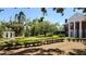 A landscaped front yard with a gazebo and manicured garden beds exudes curb appeal at 5002 S Shore Crest Cir, Tampa, FL 33609