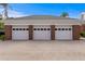 Spacious three-car garage featuring brick accents and a paved driveway for ample parking at 5002 S Shore Crest Cir, Tampa, FL 33609