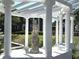 Covered garden featuring a beautiful statue, lush greenery, and views of the grand home in the background at 5002 S Shore Crest Cir, Tampa, FL 33609