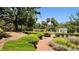 Well-maintained gardens with brick pathways and mature trees at 5002 S Shore Crest Cir, Tampa, FL 33609