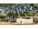 Beautifully landscaped garden featuring mature trees, stone terraces, and decorative statuary adding charm and character to the property at 5002 S Shore Crest Cir, Tampa, FL 33609