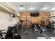 Home gym features a treadmill, weight machines, shelving, wood accent wall, and mirrored wall at 5002 S Shore Crest Cir, Tampa, FL 33609