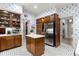 Well-lit kitchen featuring stainless steel refrigerator, wood cabinets, and tile floors at 5002 S Shore Crest Cir, Tampa, FL 33609