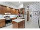 Charming kitchen with blue and white wallpaper, stainless steel appliances, and wood cabinets at 5002 S Shore Crest Cir, Tampa, FL 33609