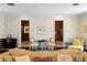 Cozy living room with dark wood floors, patterned wallpaper, and seating arrangement at 5002 S Shore Crest Cir, Tampa, FL 33609