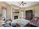 Living room features a fireplace, large mirror, custom window treatments, and hardwood floors at 5002 S Shore Crest Cir, Tampa, FL 33609