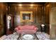 Elegant office with dark wood paneling, antique clock, and ornate mirror above patterned couch at 5002 S Shore Crest Cir, Tampa, FL 33609