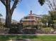 Well maintained brick home with mature trees, lush landscaping, and an American flag at 5002 S Shore Crest Cir, Tampa, FL 33609
