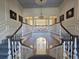 A grand staircase leads to an upper level with detailed railings and elegant lighting at 5002 S Shore Crest Cir, Tampa, FL 33609