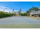 A full-size tennis court with basketball hoops sits between hedges and the house at 5002 S Shore Crest Cir, Tampa, FL 33609