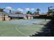 Full view of the private tennis court, complemented by lush landscaping and outdoor seating at 5002 S Shore Crest Cir, Tampa, FL 33609