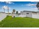 Spacious backyard with a pool, manicured lawn, a privacy fence, and tasteful landscaping at 5080 43Rd S St, St Petersburg, FL 33711