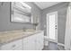 Bathroom with granite countertop vanity, gray walls, tile floor, and a decorative mirror at 5080 43Rd S St, St Petersburg, FL 33711