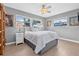 Bright bedroom with a large window, ceiling fan, neutral paint and hardwood floors at 5080 43Rd S St, St Petersburg, FL 33711