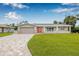 Charming single Gathering home featuring a brick driveway, two car garage, and a well manicured front lawn at 5080 43Rd S St, St Petersburg, FL 33711