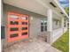 Inviting front entrance showcasing a colorful double front door, brick pathway, and shaded walkway at 5080 43Rd S St, St Petersburg, FL 33711