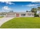Attractive single-story home with a paver driveway, lush lawn, and neutral exterior paint at 5080 43Rd S St, St Petersburg, FL 33711