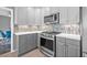 Updated kitchen showcasing stainless steel appliances, modern countertops, and backsplash, perfect for culinary enthusiasts at 5080 43Rd S St, St Petersburg, FL 33711