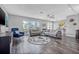 Bright living room featuring tile floors, two sofas, and large windows for ample natural light at 5080 43Rd S St, St Petersburg, FL 33711