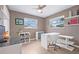 Home office with large windows, ceiling fan, neutral paint, hardwood floors, and modern desk at 5080 43Rd S St, St Petersburg, FL 33711