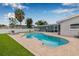 Backyard with a private screened-in pool, brick patio, lounge chairs, landscaping, and well-maintained lawn at 5080 43Rd S St, St Petersburg, FL 33711