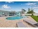 Beautiful backyard with a sparkling pool, sun loungers, brick patio, and a covered, screened lanai at 5080 43Rd S St, St Petersburg, FL 33711
