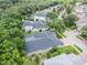 Aerial view of backyard showing pool, trees and nice neighborhood at 5101 Hartwell Loop, Land O Lakes, FL 34638