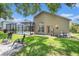 Scenic backyard featuring a screened-in pool, lush greenery, and outdoor seating at 5101 Hartwell Loop, Land O Lakes, FL 34638