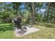 Secluded backyard space with a fire pit, shed, and mature trees at 5101 Hartwell Loop, Land O Lakes, FL 34638
