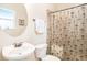 Bathroom featuring a toilet, sink, and shower with a tropical themed curtain at 5101 Hartwell Loop, Land O Lakes, FL 34638