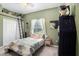 Bedroom with a cozy feel, a window, and a ladder leading to overhead storage at 5101 Hartwell Loop, Land O Lakes, FL 34638
