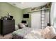 Bedroom featuring a cozy bed and a work area with a mounted TV and a rolling ladder at 5101 Hartwell Loop, Land O Lakes, FL 34638